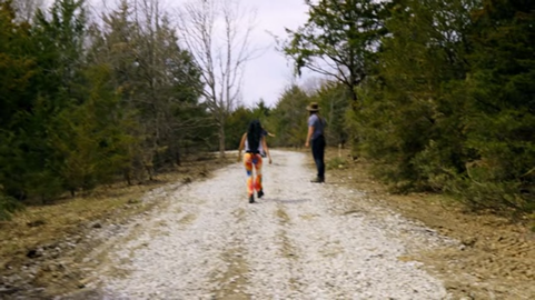 The meme is an image of a person walking in the woods, but their legs are replaced with a pair of chicken legs. The image is captioned "When you're trying to hike but your legs are having other plans".