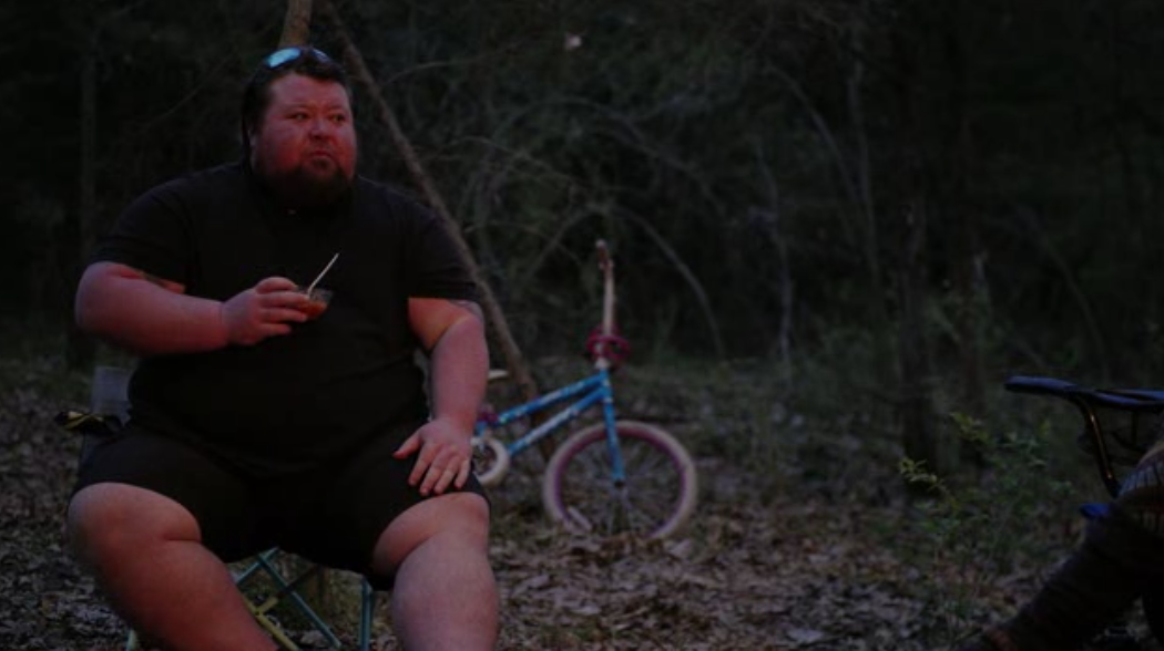 The meme features a photo of a man with a serious expression, likely from a TV show or movie, but I cannot identify the source. The text "I can smell the desperation emanating from this guy's tweets" is overlaid on th...