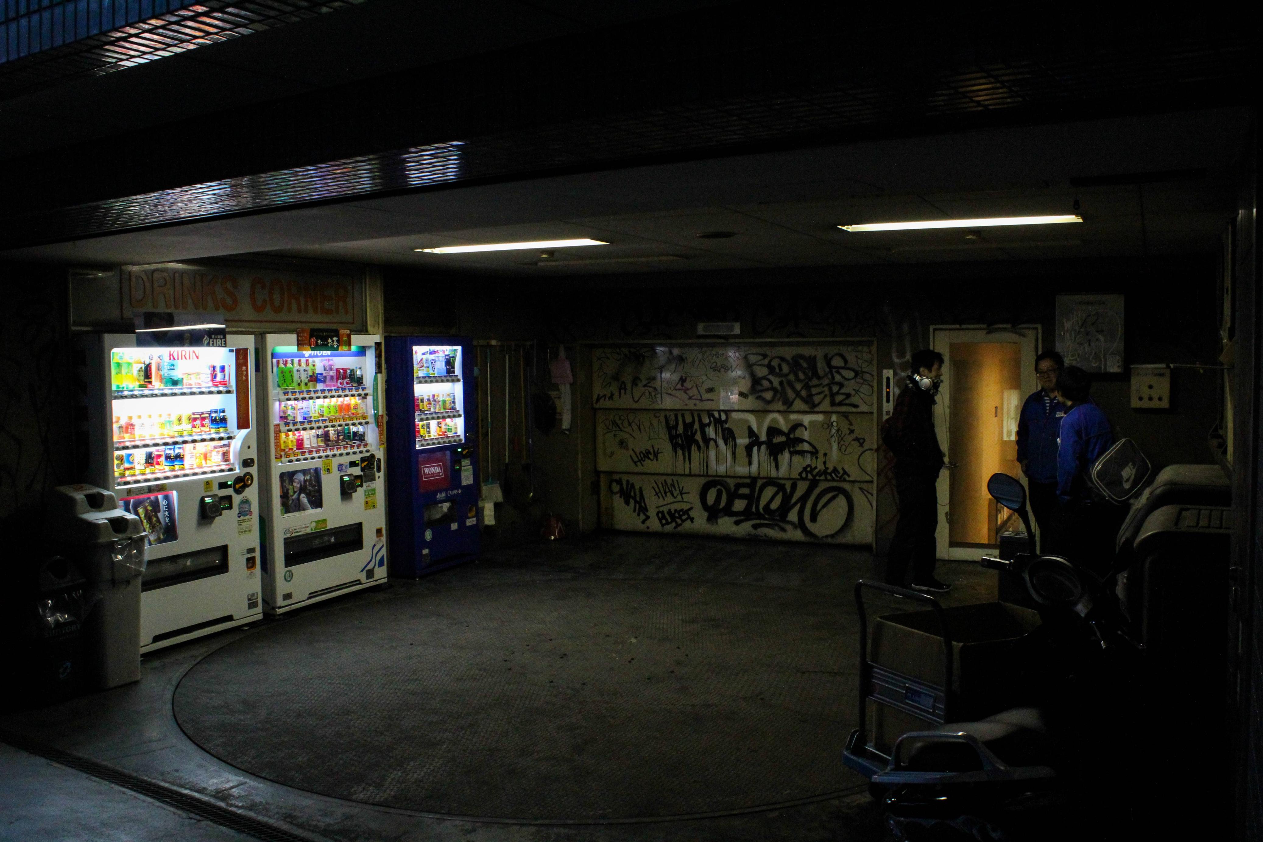 The meme is an image of a dimly lit, empty convenience store or "7-Eleven" with a single, flickering fluorescent light overhead. The image is captioned "7-Eleven: Where the only thing more depressing than the store is the people in it."
