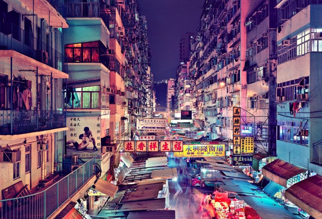 The meme is an image of a crowded and chaotic street in Hong Kong at night, with neon lights and billboards illuminating the dark sky. The text "I can smell the desperation" appears in a bold, graffiti-style font across the top of the image. The image is meant to evoke a sense of overwhelm and anxiety, with the text adding a sense of irony and humor to the scene.