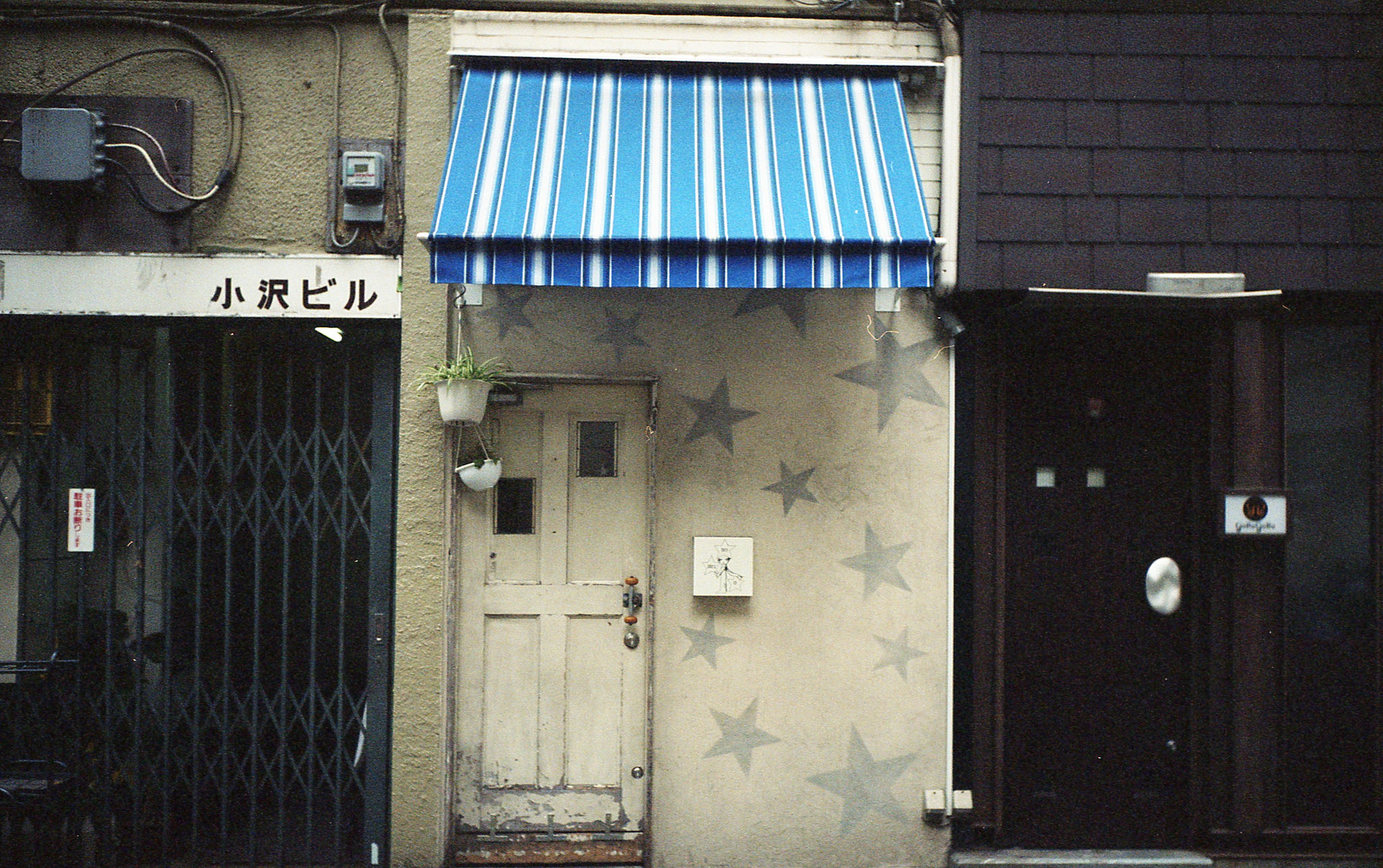 The meme is an image of a small, rundown storefront with a sign that reads "Tokyo" in Japanese characters. The sign is above a door with a small window, and the door is slightly ajar.
