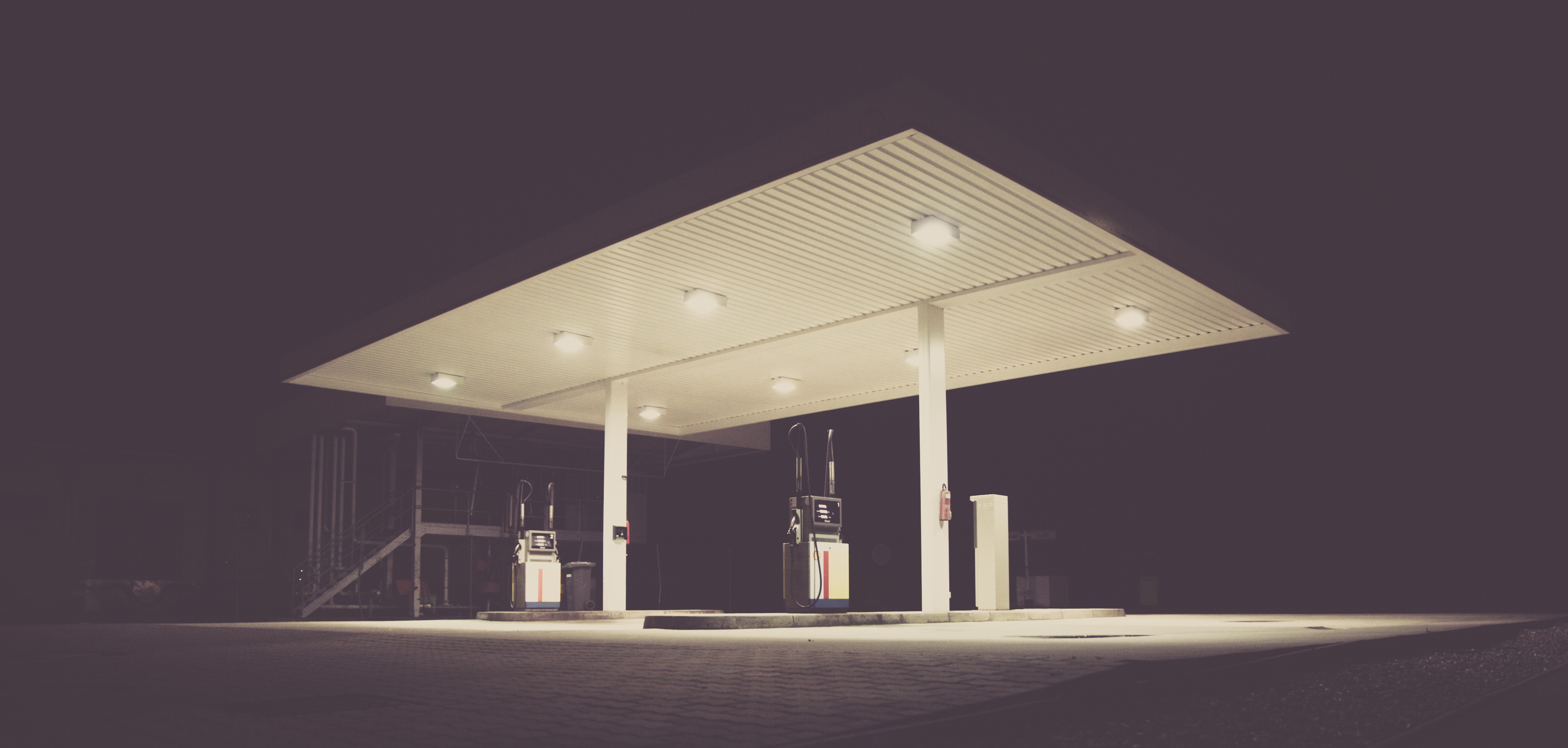 This meme is an image of a gas station at night with the pumps and lights turned off. The image is captioned "When you finally get to a place that's been closed for hours".