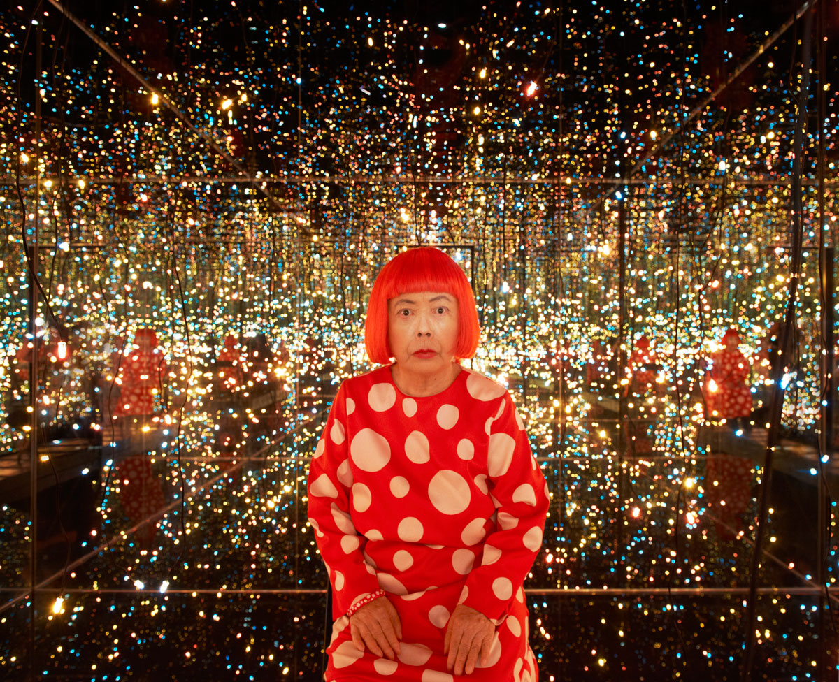 The meme is a photo of the Japanese artist Yayoi Kusama, who is known for her colorful and playful style. The image shows her standing in a room filled with thousands of twinkling lights, which are actually a part of her art installation "Infinity Mirror Rooms". The text that appears in the image is not explicitly mentioned, but the meme is likely a humorous take on Kusama's famous style, exaggerating her love of bright colors and whimsical art.