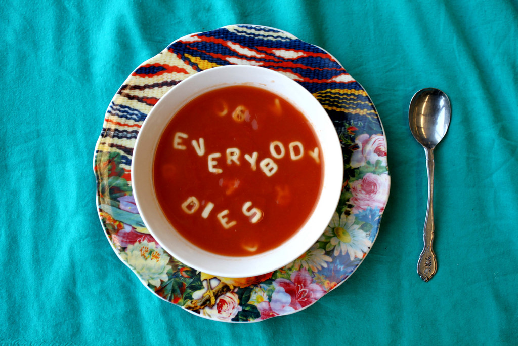 The meme is a humorous image of a bowl of soup with the words "EVERYBODY DIES" spelled out in the soup using bread or croutons. The image is likely a playful reference to the phrase "Everybody dies" from the popular video game series "The Elder Scrolls" and the fantasy novel "The Last of Us". The meme is likely used to express a sense of morbid humor or to poke fun at the idea that even in a fictional game or story, the characters can still meet a gruesome end.
