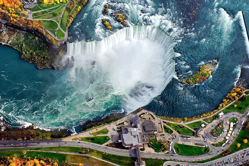 The meme is an image of a famous waterfall, likely Niagara Falls, but with the water turned into a giant toilet bowl. The image is captioned "When you finally get to the bathroom after a 12-hour drive".
