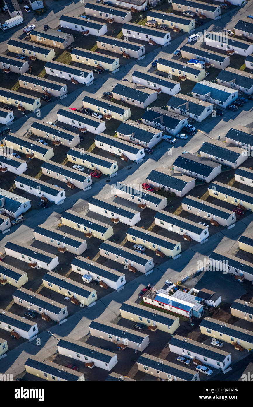 The meme is an image of a sprawling suburban development with rows of identical, low-cost homes, often referred to as "trailer parks" or "mobile home communities." The image is captioned "Permaculture - Shelter" and i...