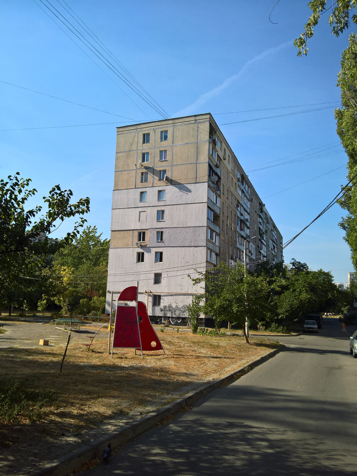 This meme is an image of a large, grey concrete building with a few windows and a small playground in the front yard. The image is captioned "Permaculture - Shelter" and the text is likely referencing the idea that a...