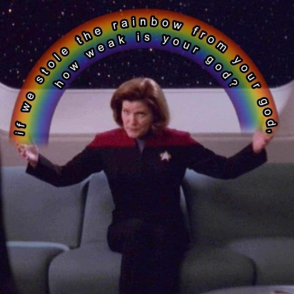 This meme is a humorous image of the character Captain Janeway from the TV show Star Trek: Voyager, with a caption that reads "Infinite Improbability Drive: Because who needs a functioning spaceship when you can just make up science?"