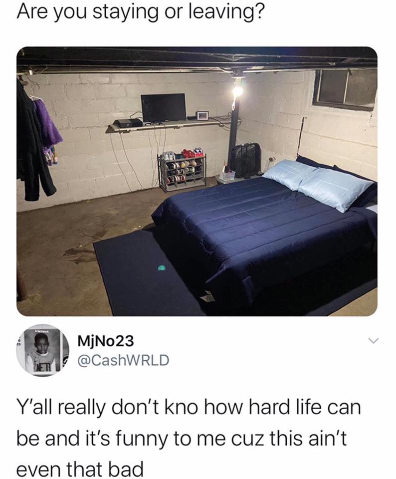 The meme is a photo of a small, cluttered room with a bed, TV, and various belongings. The caption "Are you staying or leaving?" is written above the image, and the response "In here" is written below. The meme is humorous because the room is so small and cramped that it's not clear if the person is staying or leaving, and the response is a deadpan joke about the absurdity of the situation.