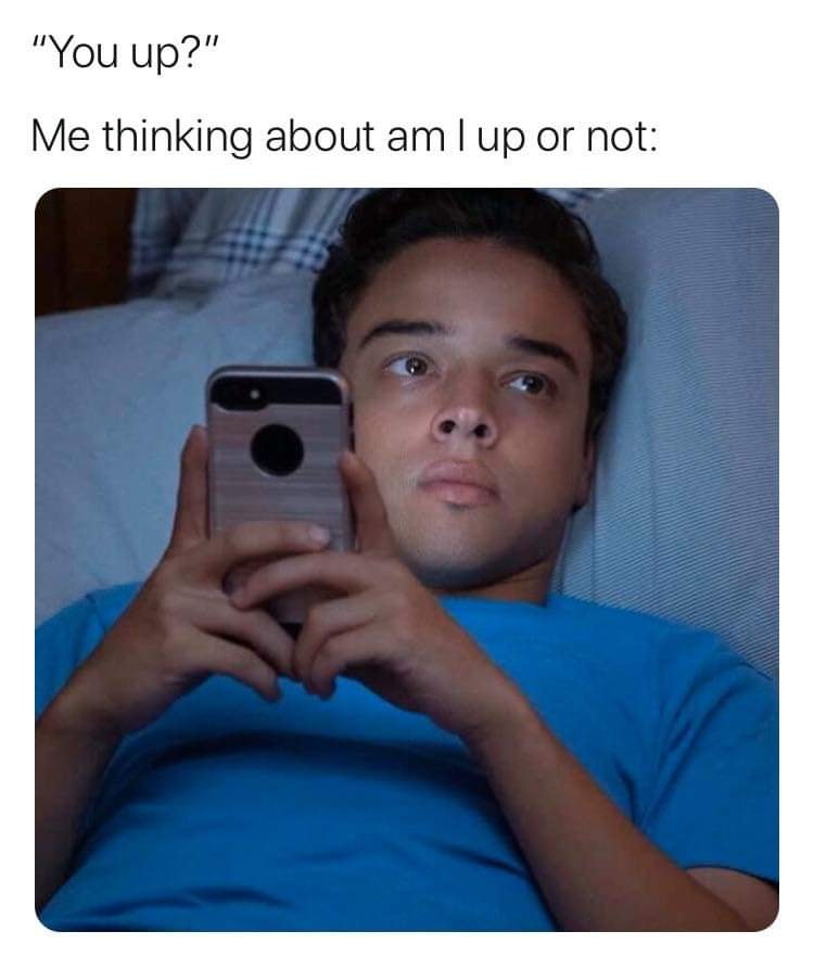 This meme features a person lying in bed, looking at their phone with a confused expression. The text above the image reads, "You're telling me I've been lying here for hours and I'm still not awake?" and below, "I think I'm still asleep". The meme is poking fun at the experience of waking up in the middle of the night and wondering if you're still dreaming or awake.