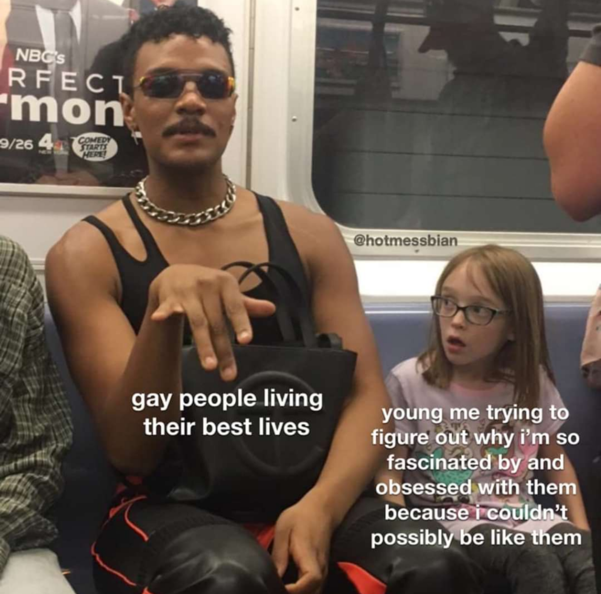 This meme features a photo of a young boy and a man, with text overlaid on the image. The man is wearing a black tank top and has a confident expression, while the boy looks on with a mix of confusion and concern. The text reads: "gay people living their best lives / i'm a young adult and i'm still trying to figure out why i'm so obsessed with them".