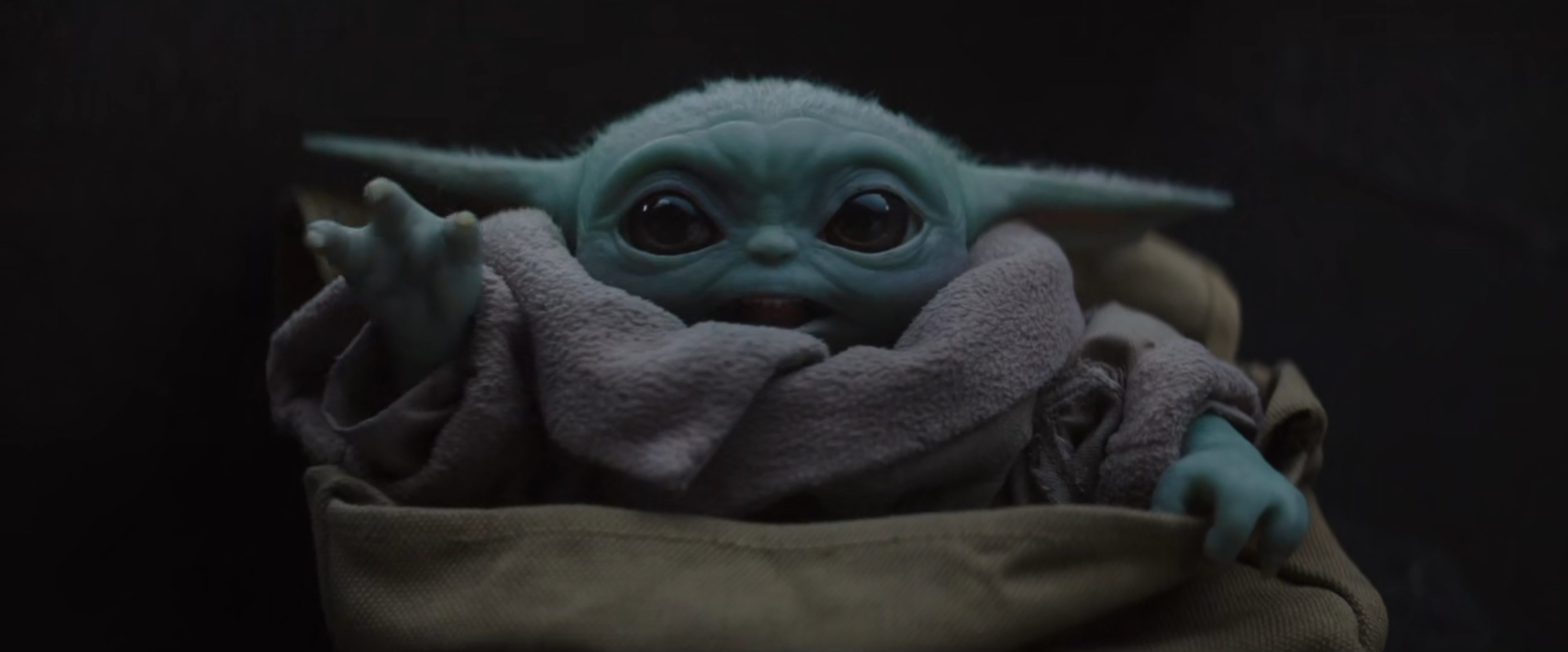 Okay, let's break down this image of "Baby Yoda" (Grogu from *The Mandalorian*) through various theoretical lenses. ## Visual Description The image is a close-up shot of Grogu, a creature belonging to the same species...