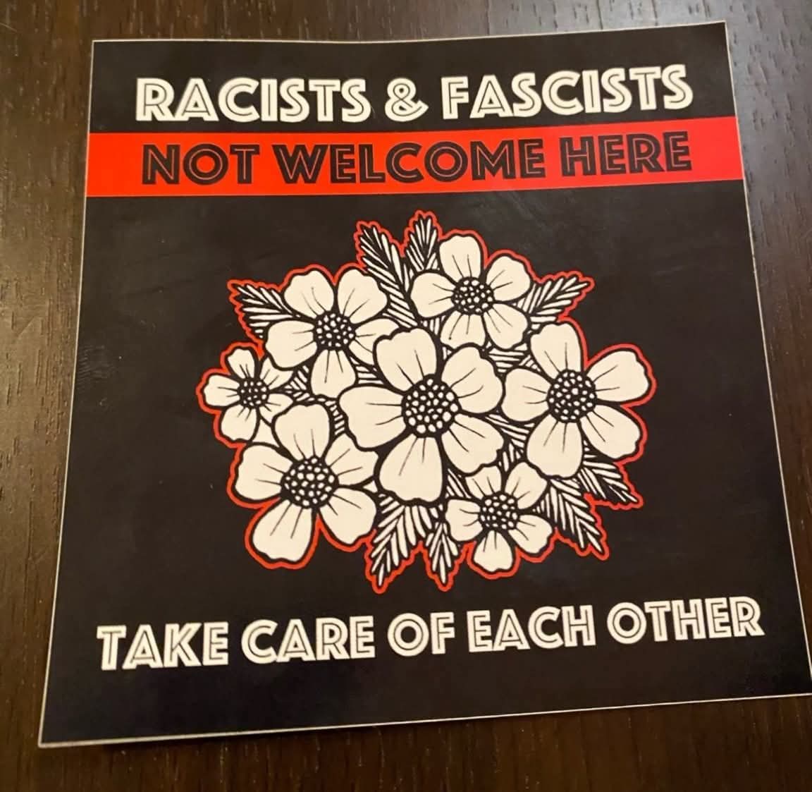 This meme is a sticker that expresses a strong opinion on a specific topic. The text on the sticker reads "RACISTS & FASCISTS NOT WELCOME HERE" in a bold and clear font, indicating that the person who put it on their...