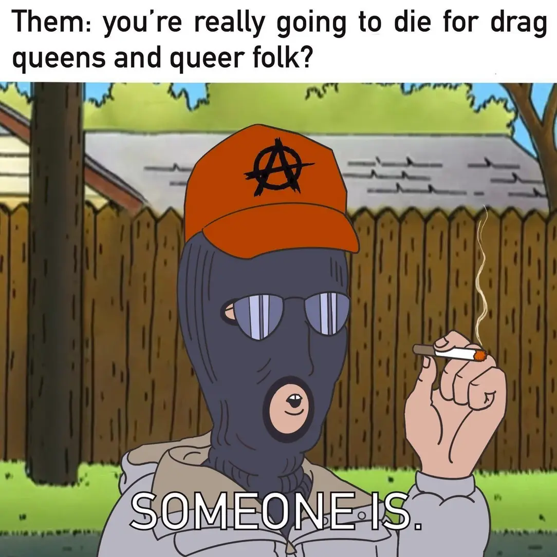 This meme features an image of a character from the TV show "Rick and Morty" wearing a helmet and a mask, holding a cigarette and looking unimpressed. The text at the top reads "You're going to die from a gay virus" and at the bottom reads "In a world where everyone is a victim of the system, some of us are dying from a gay virus". The character is responding to this statement with a sarcastic "In that case, I'll just die from a gay virus then" and the text "You're going to die for being gay" is crossed out and replaced with "You're going to die for being a victim of the system".