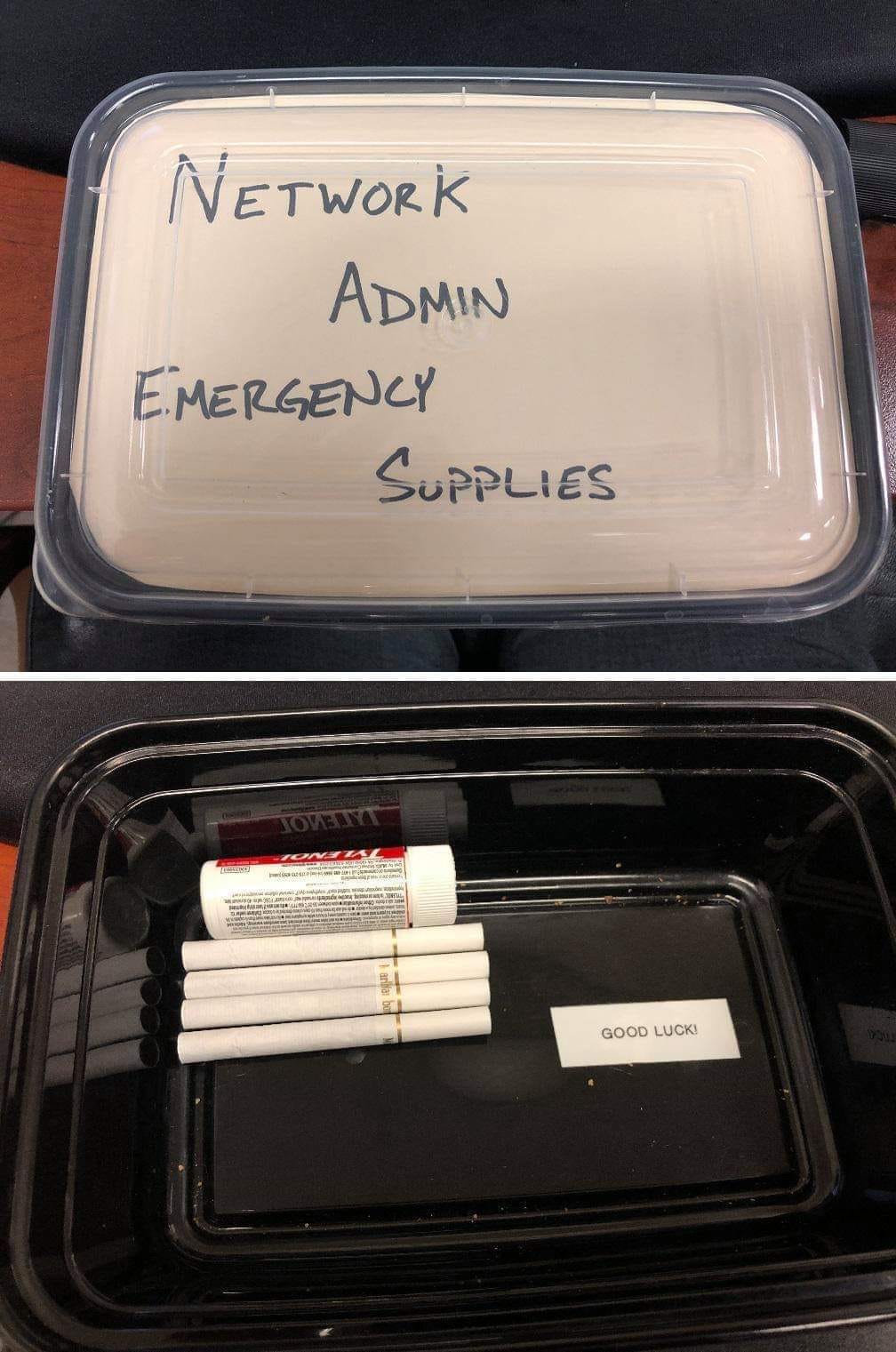 The meme is a picture of a container labeled "In Case of Emergency: Break Glass" with a few items inside, including a first aid kit, a fire extinguisher, and a small notebook. However, the items inside are actually a bottle of whiskey, a pack of cigarettes, and a box of "Emergency" chocolate. The text on the label reads "In Case of Emergency: Break Glass / For Emergency Use Only: Break Glass / In Case of Emergency: Break Glass".