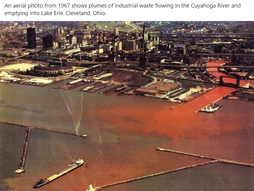 This meme is a photo of the Cuyahoga River in Cleveland, Ohio, which caught fire in 1969 due to pollution. The image shows the river's water on fire, with flames licking the shore and boats floating in the background. The caption reads, "The Cuyahoga River, where the water is so polluted, it's on fire."